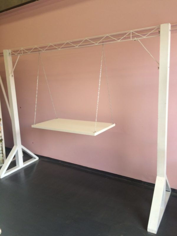 White arbor with cake swing