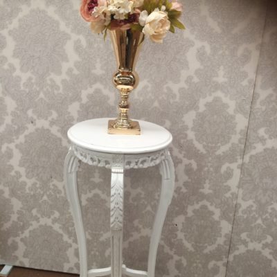 Tall white round pedestals