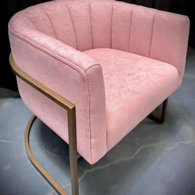 Pink and gold curved velvet armchair