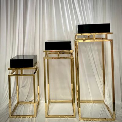 Set of three black top and gold lux pedestals