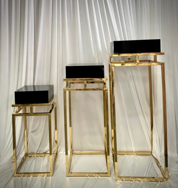 Set of three black top and gold lux pedestals