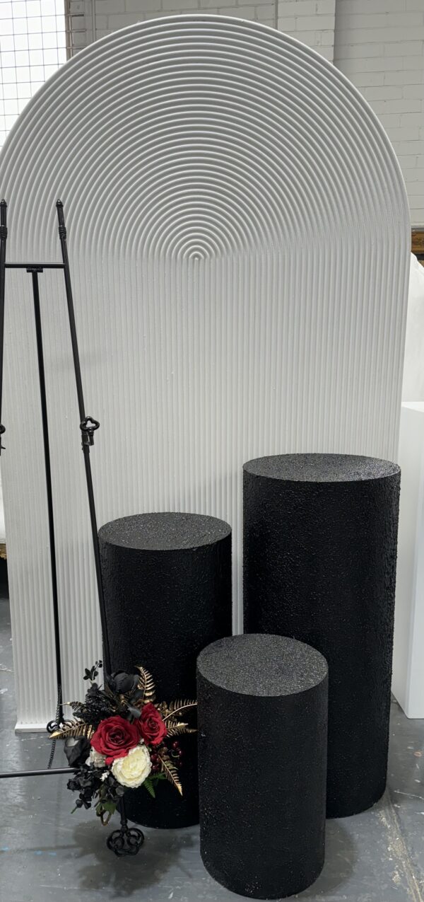 Set of three black round textured plinths